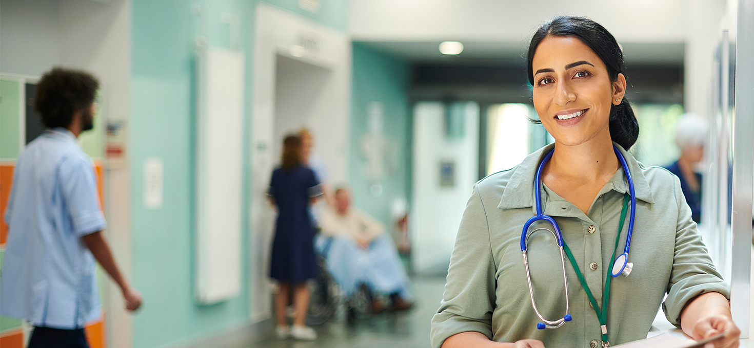 Smiling doctor in hospital hallway